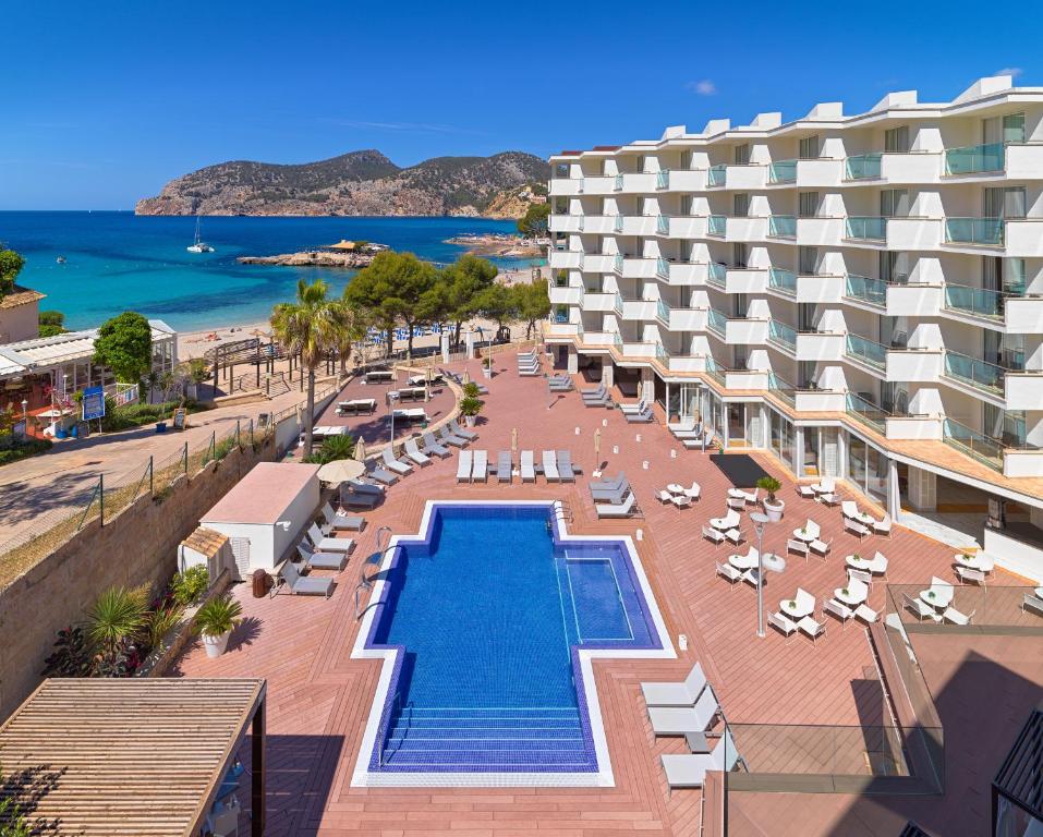 a resort with a swimming pool and chairs and a beach at Boutique Hotel H10 Blue Mar - Adults Only in Camp de Mar