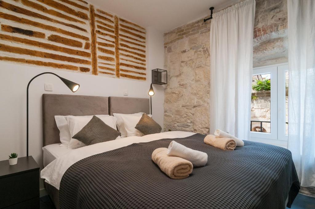 a bedroom with a large bed with towels on it at Luxury rooms 7heaven Palace in Split