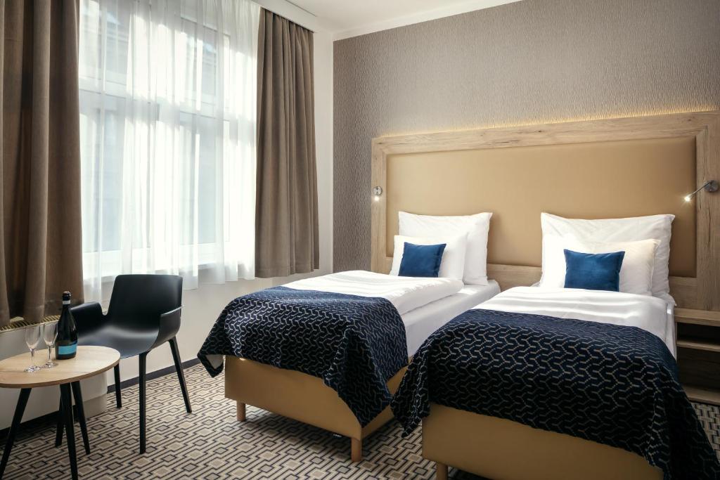 Postel nebo postele na pokoji v ubytování Astoria Hotel