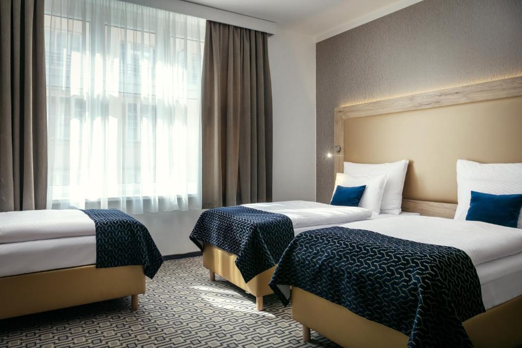 Postel nebo postele na pokoji v ubytování Astoria Hotel