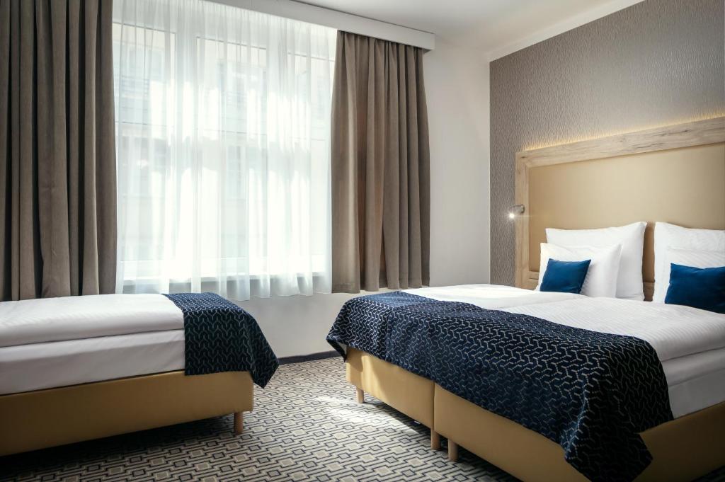 Postel nebo postele na pokoji v ubytování Astoria Hotel