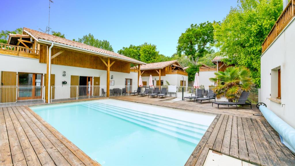 uma imagem de uma piscina numa casa em Vacancéole - Les Rives du Lac em Lacanau