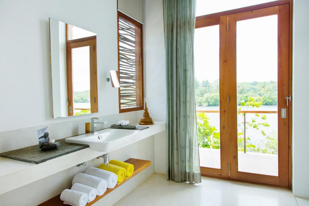 a bathroom with a sink and a mirror at Tri by Amaya in Ahangama
