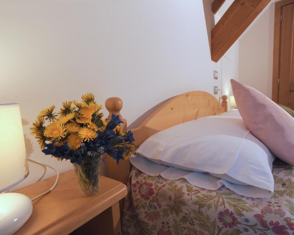 En eller flere senger på et rom på Albergo Diffuso Ravascletto