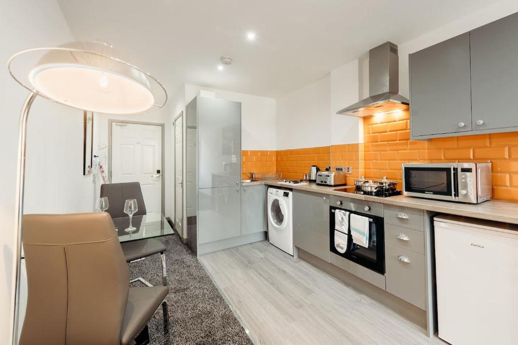 a kitchen with a table and a microwave at Halifax House, Studio Apartment 209 in Halifax