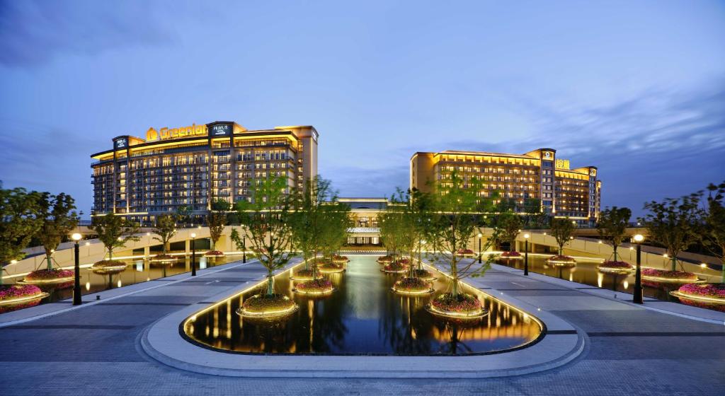 a city with a river in front of two buildings at Primus Hotel Shanghai Sanjiagang - Offer Pudong International Airport and Disney shuttle in Shanghai