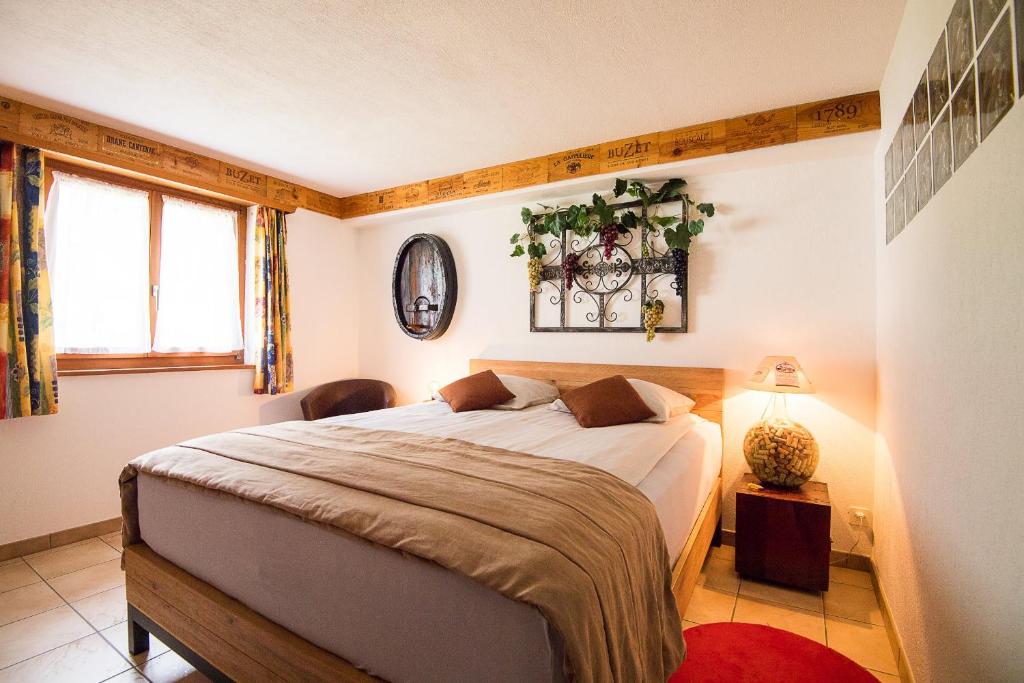 a bedroom with a bed and a lamp and a window at Rêves Gourmands, Hôtellerie & Gastronomie in Vernayaz