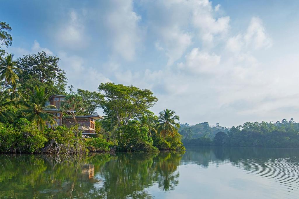 a house on an island in the middle of a river at Tri by Amaya in Ahangama