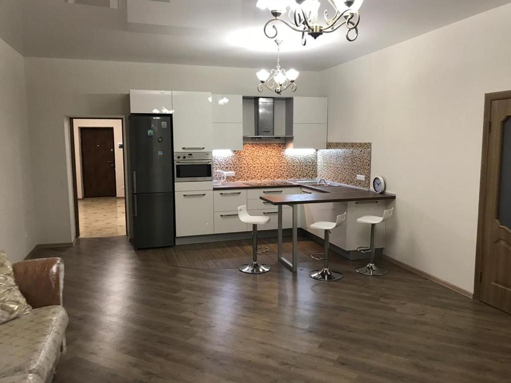 a kitchen with a table and chairs in a room at Квартира с видом на море in Chornomorsk