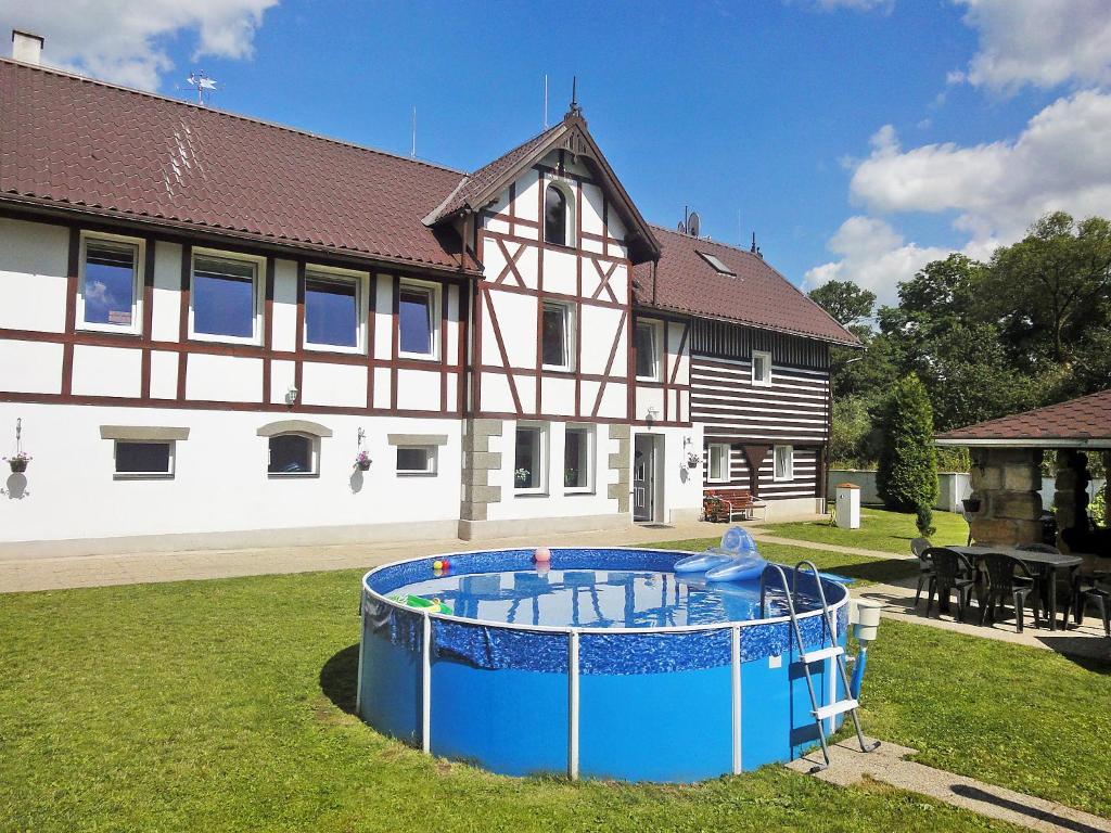 a house with a pool in front of a yard at Holiday Home Sezímky by Interhome in Stvolínky