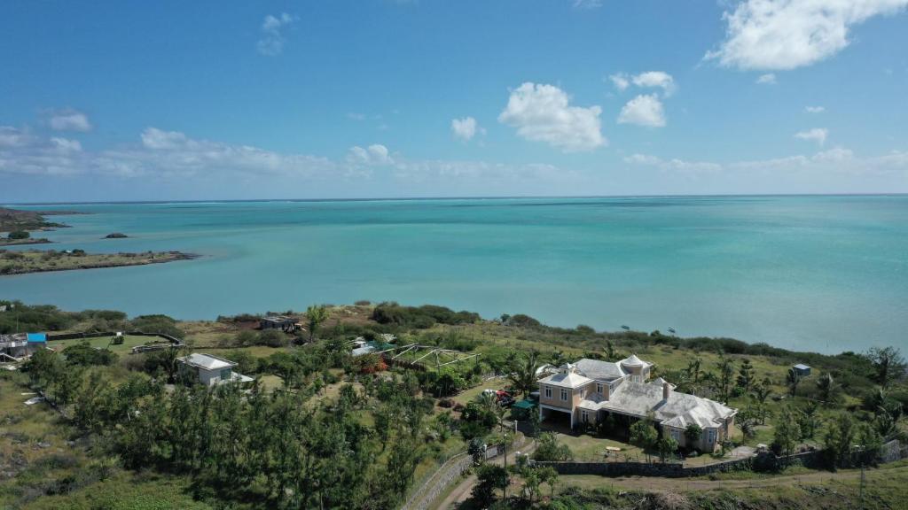 an aerial view of a house and the ocean at Le Refuge in Rodrigues Island