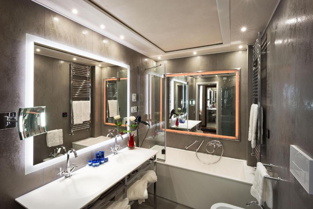 a bathroom with two sinks and two mirrors at Hotel Santa Chiara in Venice