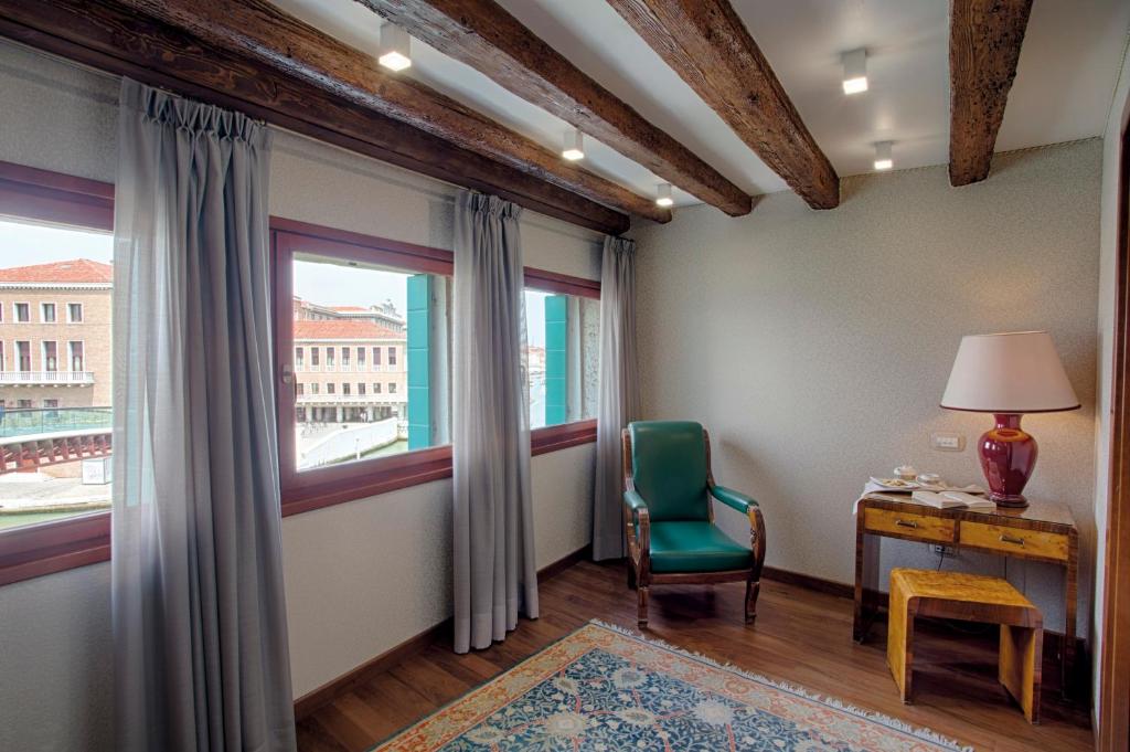 a room with a desk and a chair and a window at Hotel Santa Chiara in Venice