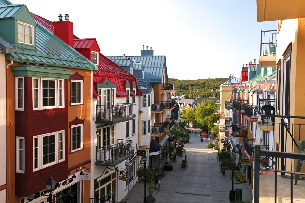 a view of a city street with colorful buildings at Place Saint Bernard Mont Tremblant in Mont-Tremblant