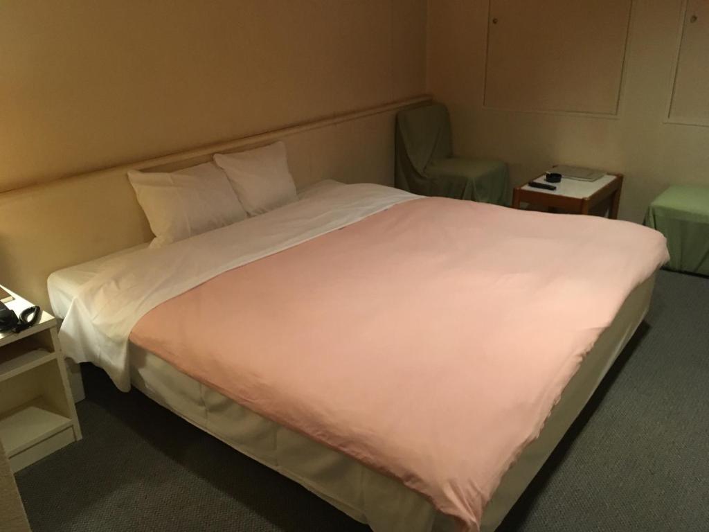 Postel nebo postele na pokoji v ubytování Hotel Noel