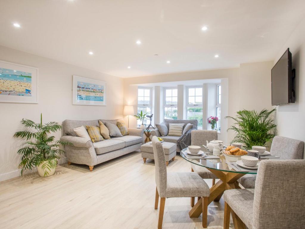 a living room with a couch and a table at The Beach Pad in Benllech