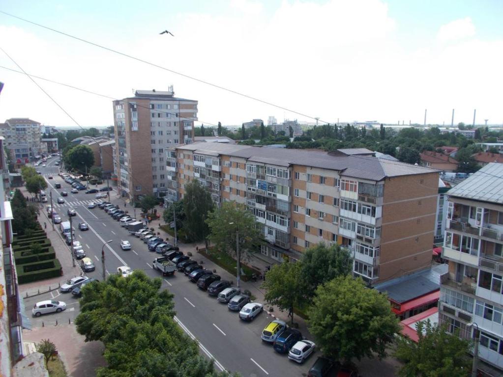 une vue aérienne sur une rue de la ville avec des voitures garées dans l'établissement Apartament Tanya, à Târgovişte
