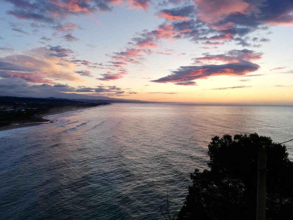a view of the ocean at sunset at Luna Convento Copanello B&B in Stalettì