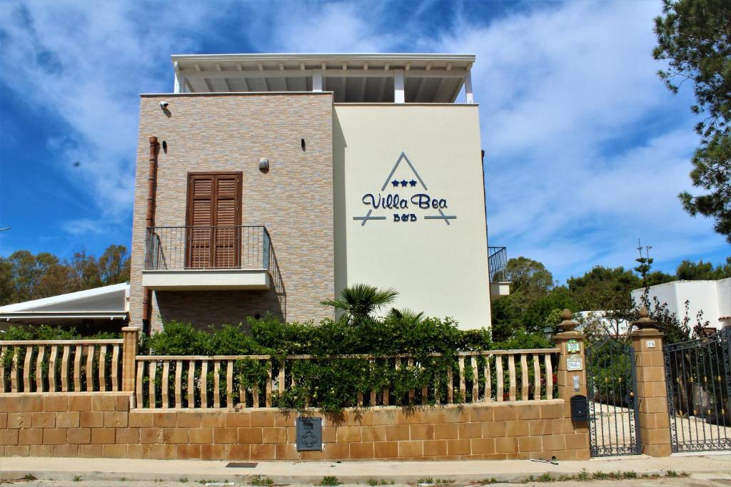 a building with a fence in front of it at B&B Villa Bea in San Vito lo Capo