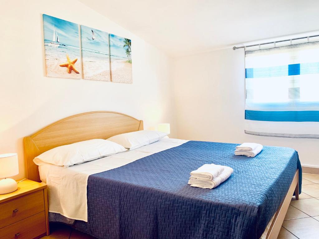 1 dormitorio con 1 cama con 2 toallas en Emilio's, en Marina di Ragusa