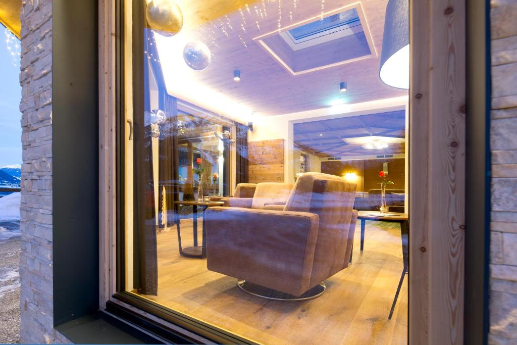 a view of a salon with chairs in a window at Hotel Bergland in Pertisau