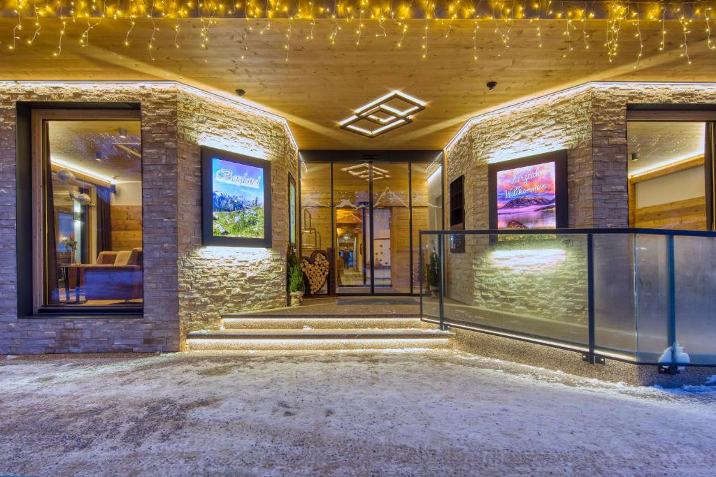 a house with lights on the front of it at Hotel Bergland in Pertisau