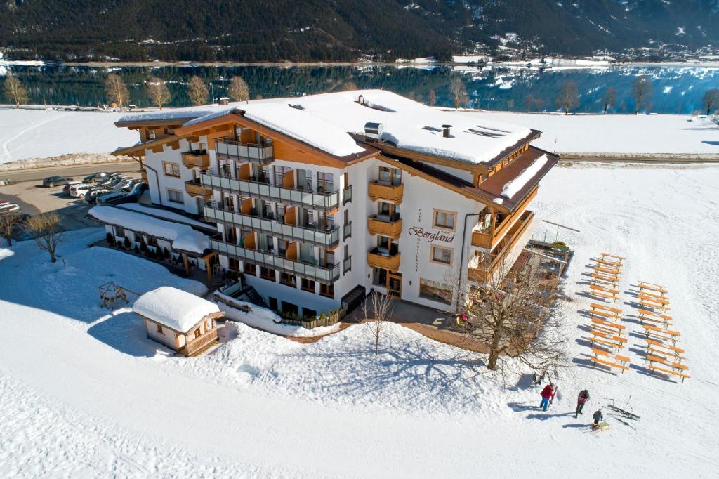 an aerial view of a hotel in the snow at Hotel Bergland in Pertisau