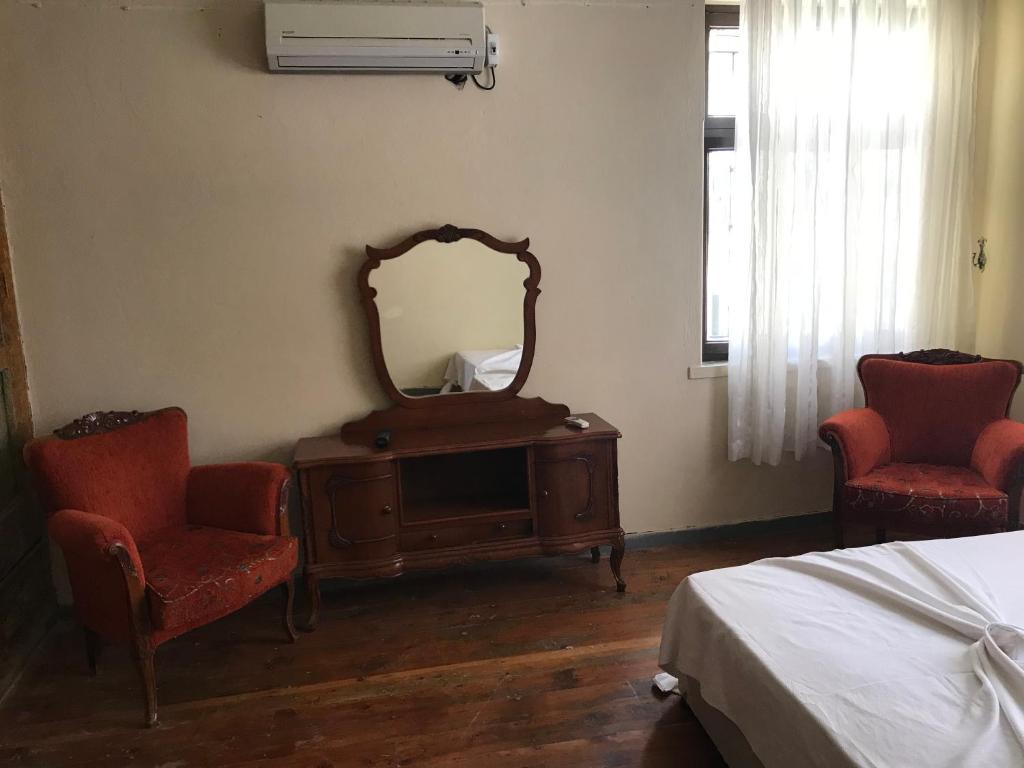 Postel nebo postele na pokoji v ubytování Bayraktar Konağı City Center