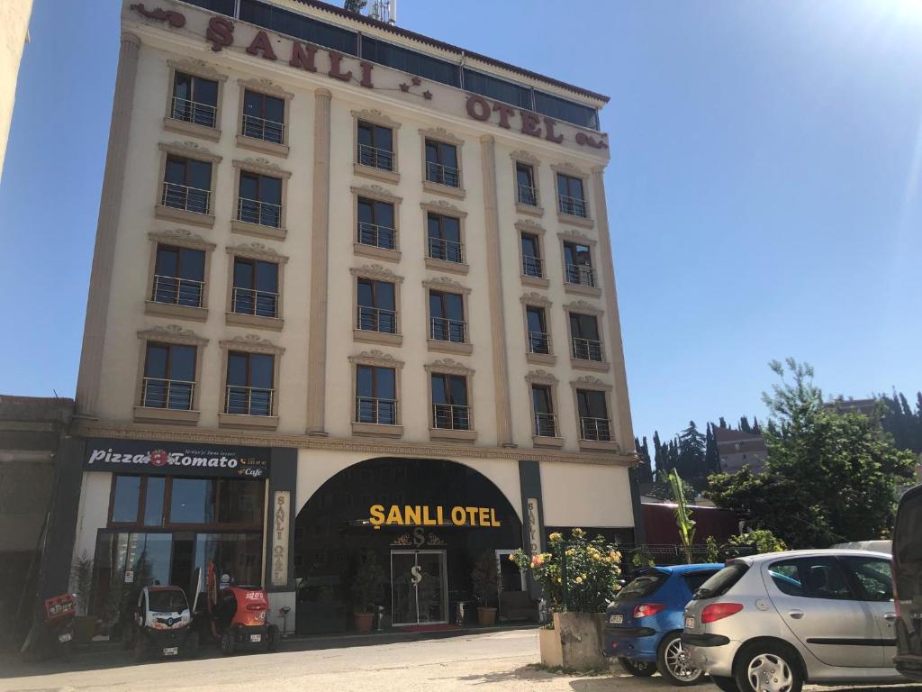a large white building with a sign on it at Sanli Hotel Hammam & SPA in Trabzon