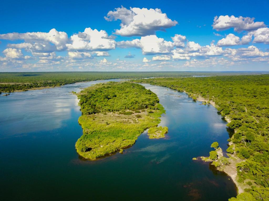 - une vue aérienne sur une rivière avec des îles vertes dans l'établissement Tsowa Safari Island, à Victoria Falls