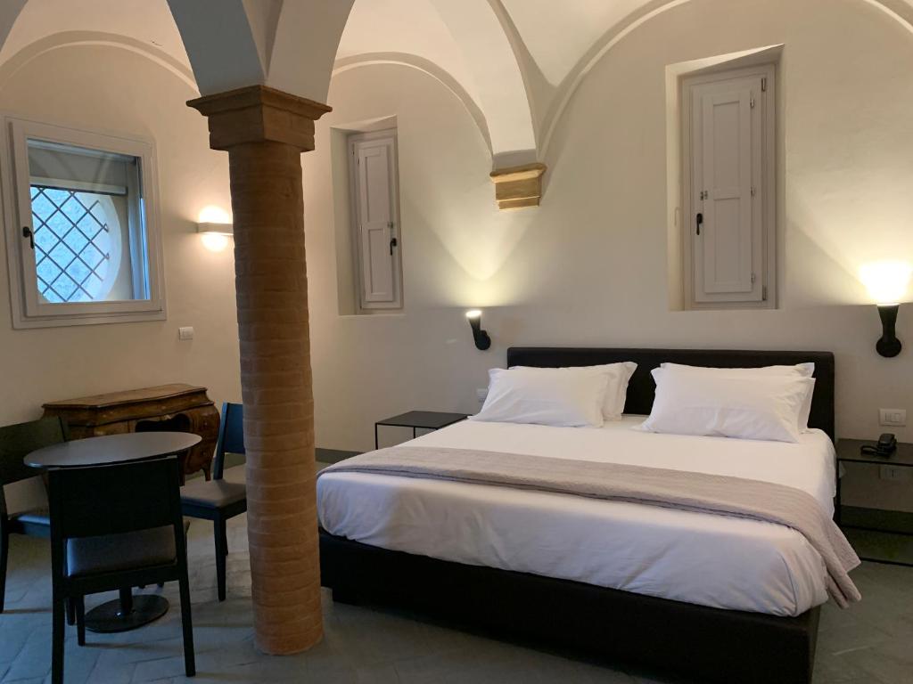 Un pat sau paturi într-o cameră la PALAZZO DE' ROSSI HOTEL