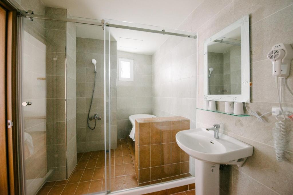 a bathroom with a shower and a sink at He Sen B&B in Kenting