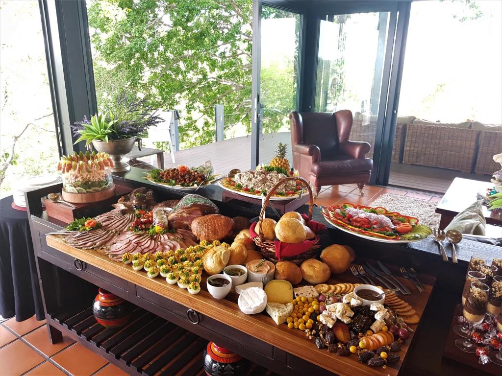 a table filled with lots of different types of food at Greenfire Game Lodge in Balule Game Reserve