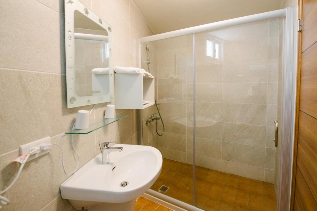 a bathroom with a sink and a shower at He Sen B&B in Kenting