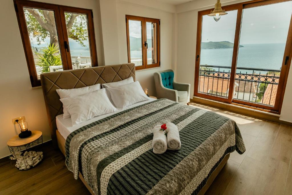 a bedroom with a bed with two stuffed animals on it at Apartments Belvedere in Herceg-Novi