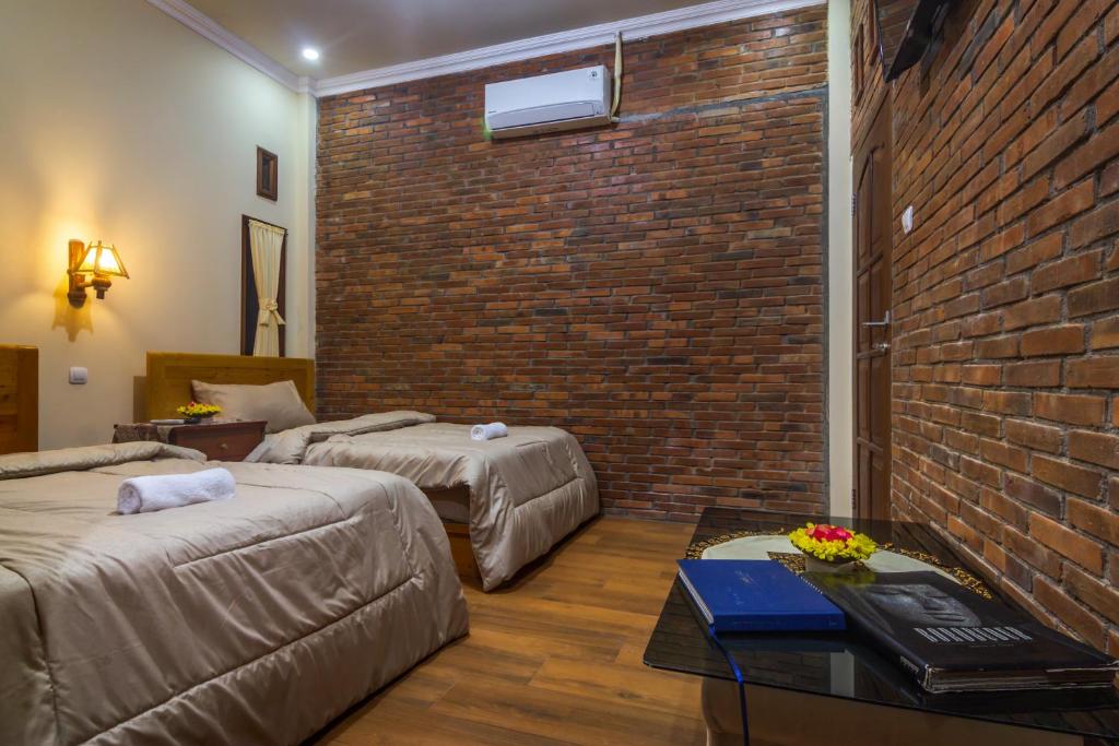 Postel nebo postele na pokoji v ubytování Maher House Borobudur