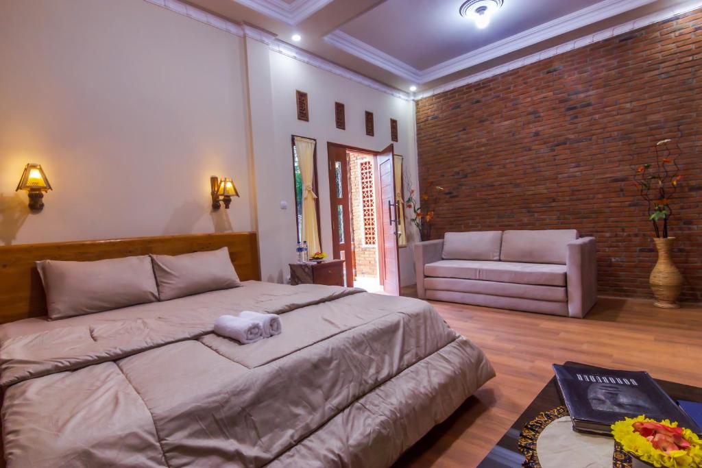 Postel nebo postele na pokoji v ubytování Maher House Borobudur