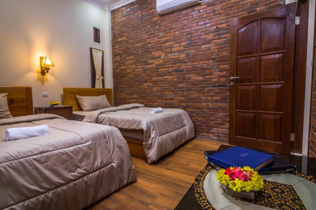 Postel nebo postele na pokoji v ubytování Maher House Borobudur