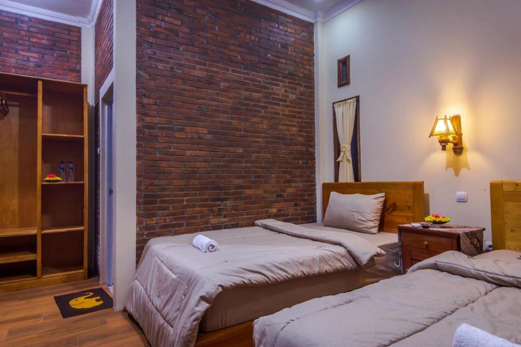 Postel nebo postele na pokoji v ubytování Maher House Borobudur
