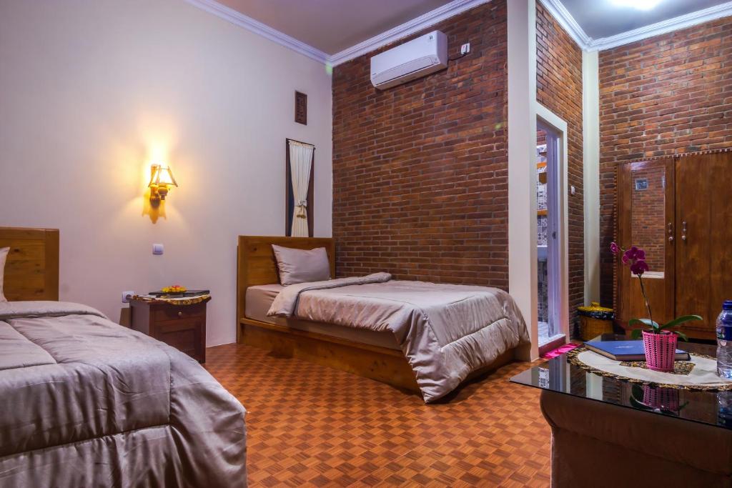 Postel nebo postele na pokoji v ubytování Maher House Borobudur