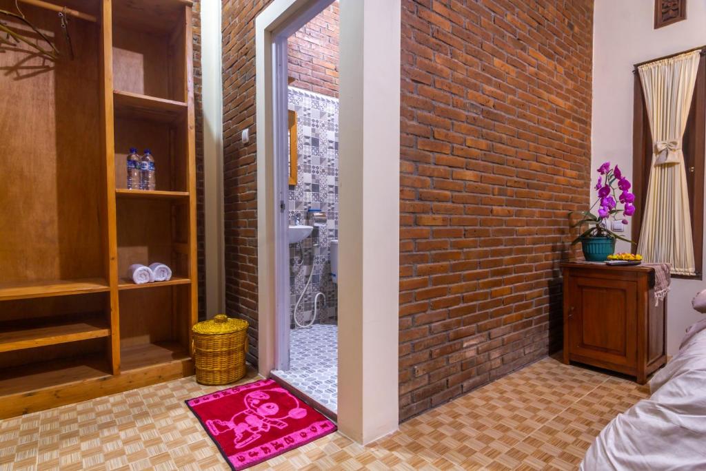 Postel nebo postele na pokoji v ubytování Maher House Borobudur