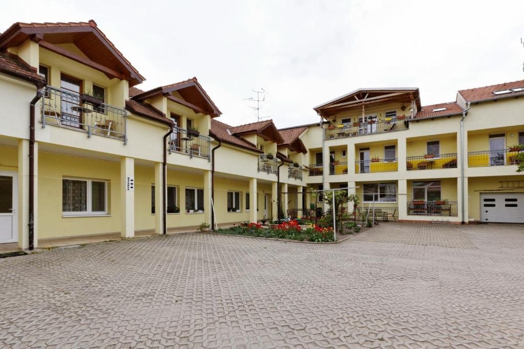 a courtyard of an apartment building with a driveway at Penzion Jordán in Lednice