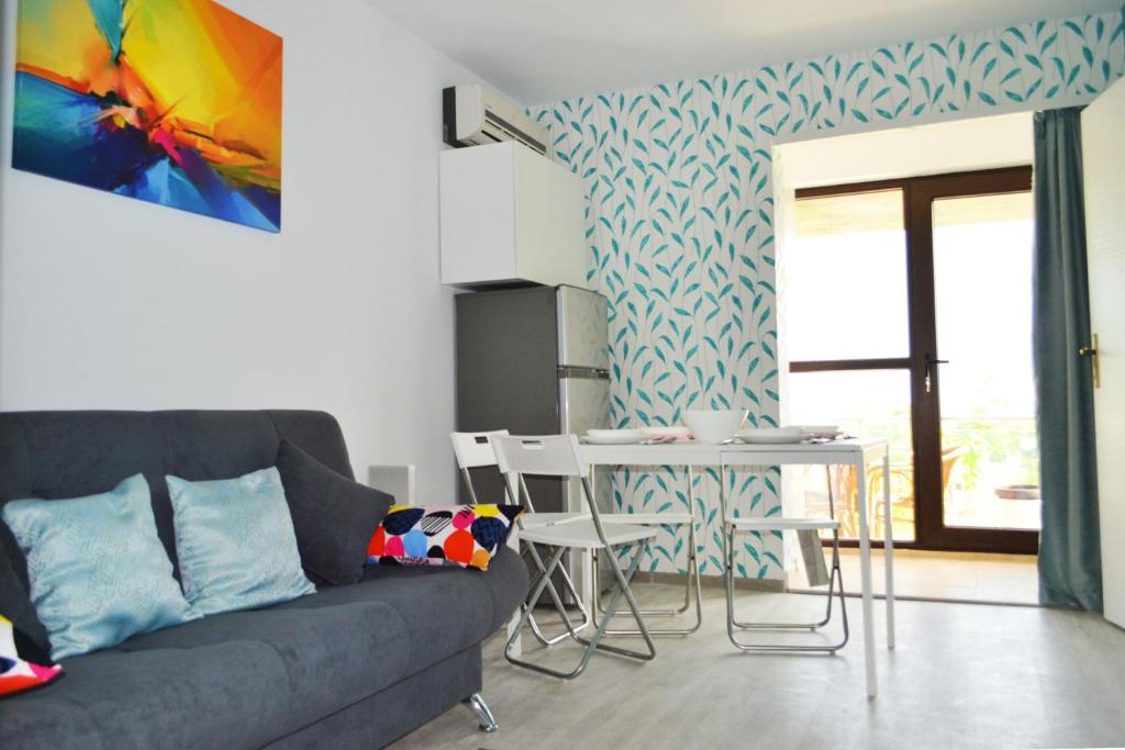 a living room with a couch and a table at LUCA Apartments in Saturn