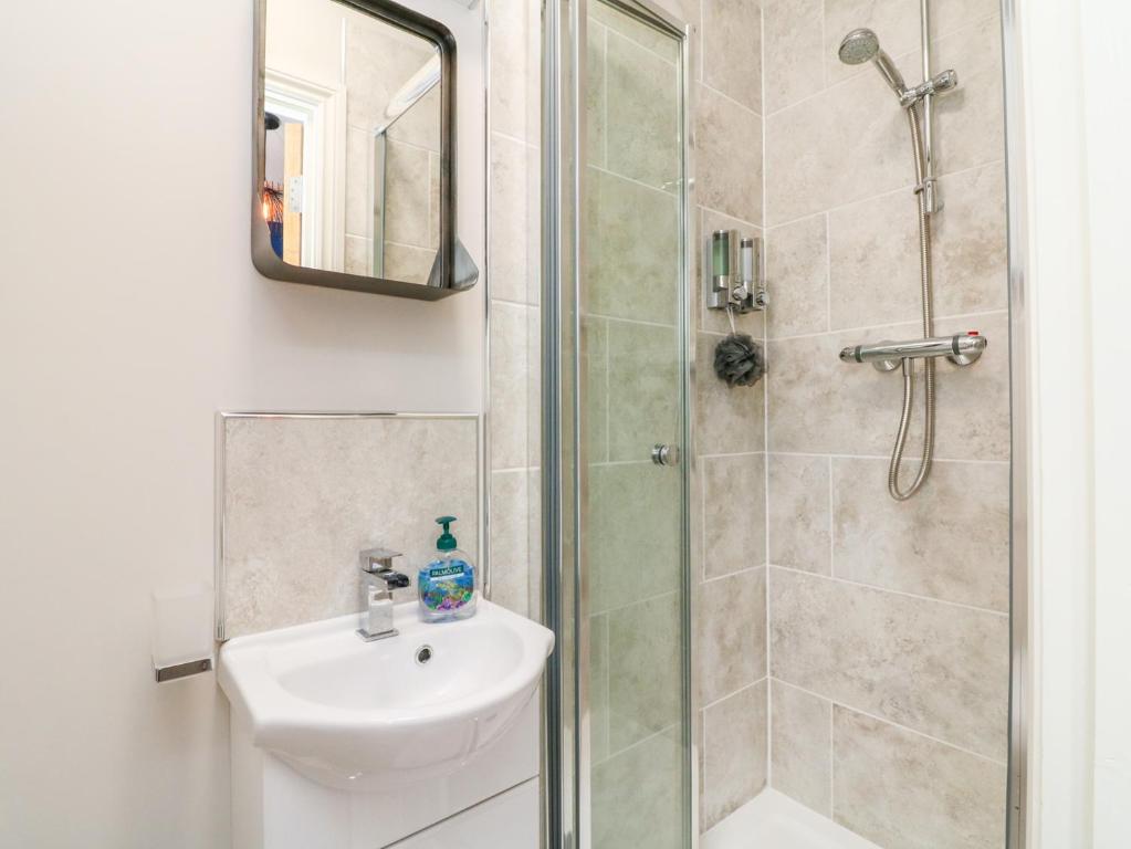 a bathroom with a sink and a shower at SeaSound in Ilfracombe