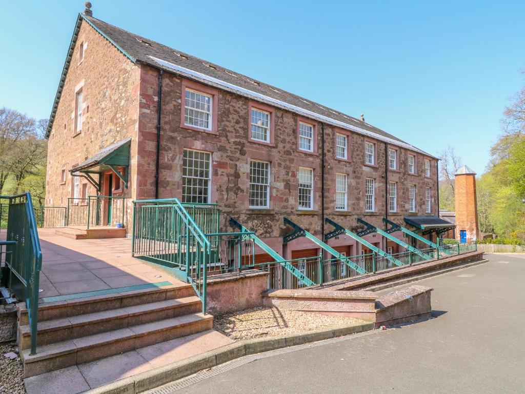 a large brick building with stairs in front of it at 12 Keathbank Court in Blairgowrie