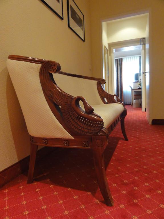 a wooden chair sitting in a room at Pension Zeitlos in Potsdam