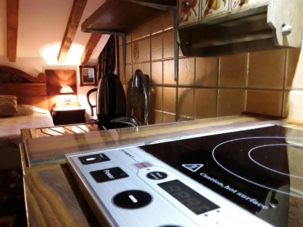 a kitchen with a stove top oven in a room at Studios Kono in Kotor