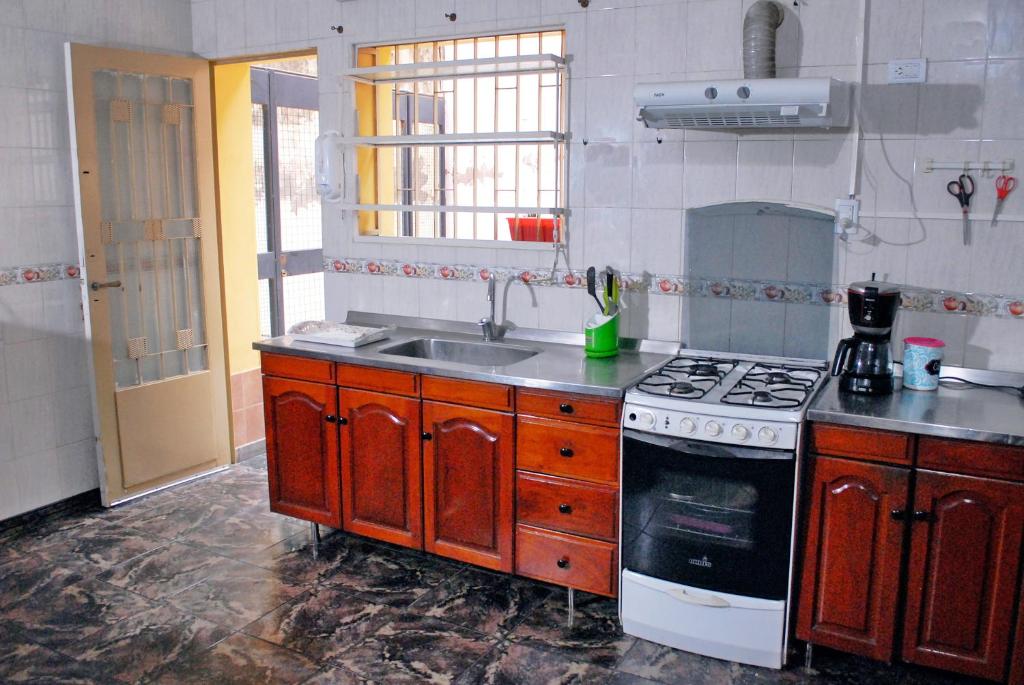 a kitchen with a sink and a stove at La Rojarilla in San Miguel de Tucumán