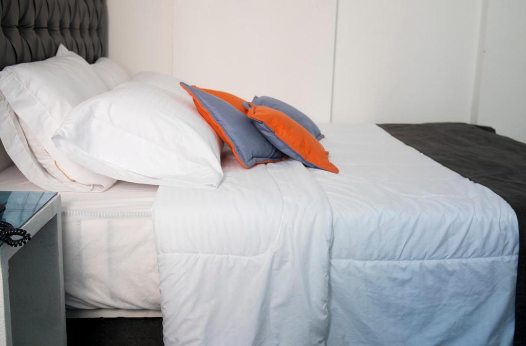 Postel nebo postele na pokoji v ubytování Hotel Grand H&R