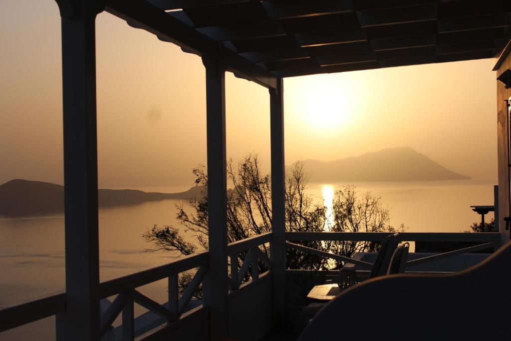 a view of the sunset from the porch of a house at Studios Betty in Plaka Milou